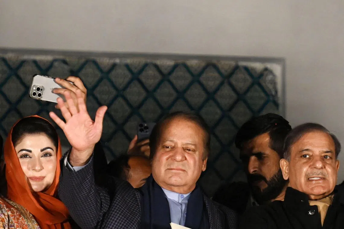 Mr Nawaz Sharif (centre) waves to supporters, a day after Pakistan's national elections.