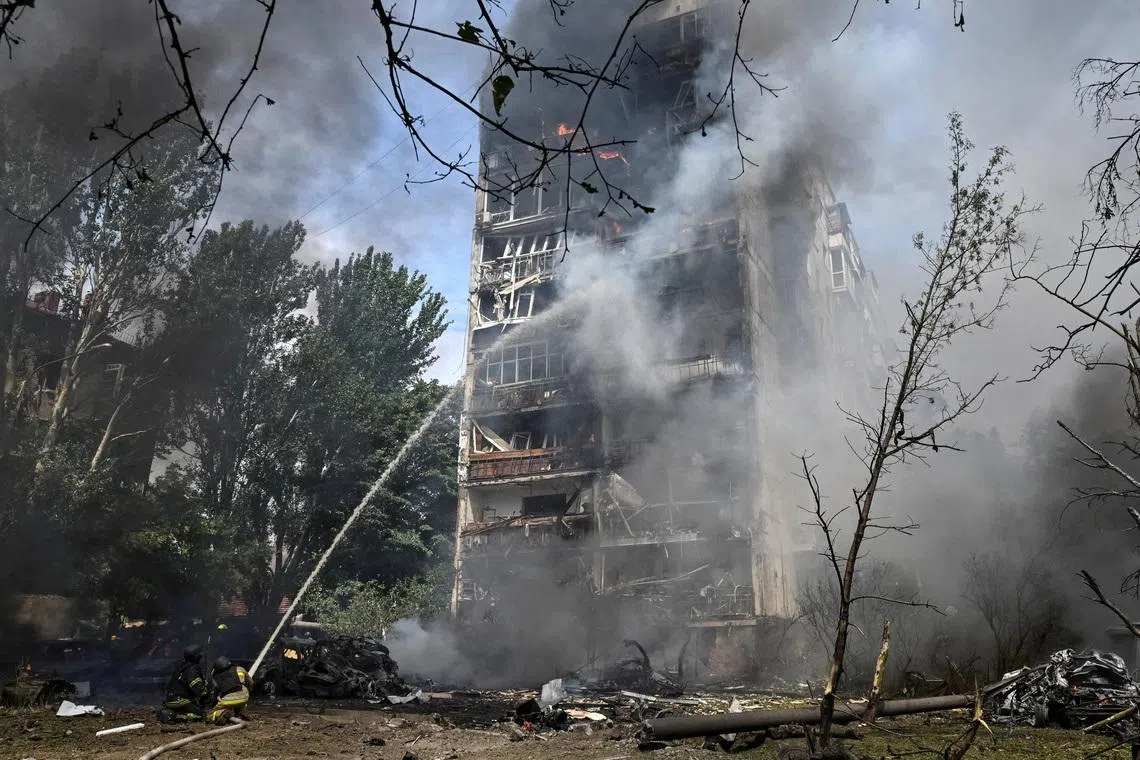 Rescuers working at the site of an apartment building hit by a Russian air strike, in Zaporizhzhia, Ukraine, on July 21.