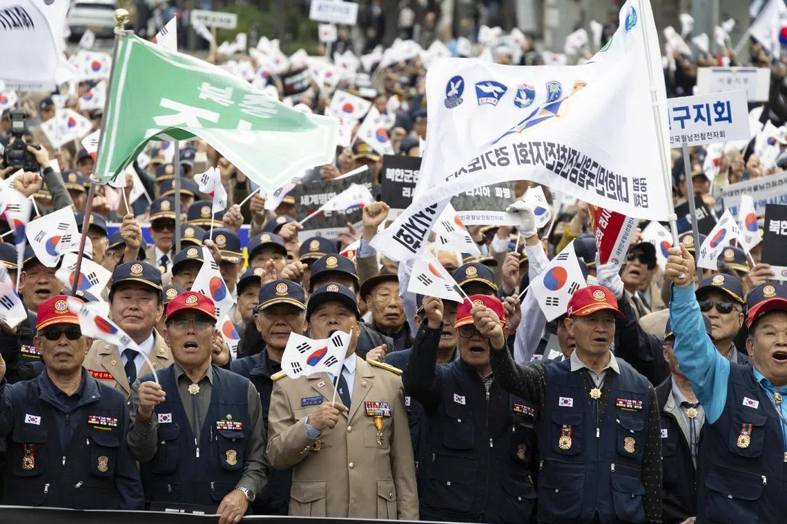 Members of the Korean Vietnam War Veterans Association hold a rally in downtown Seoul on Oct 28 to protest North Korea's deployment of troops to Russia.  