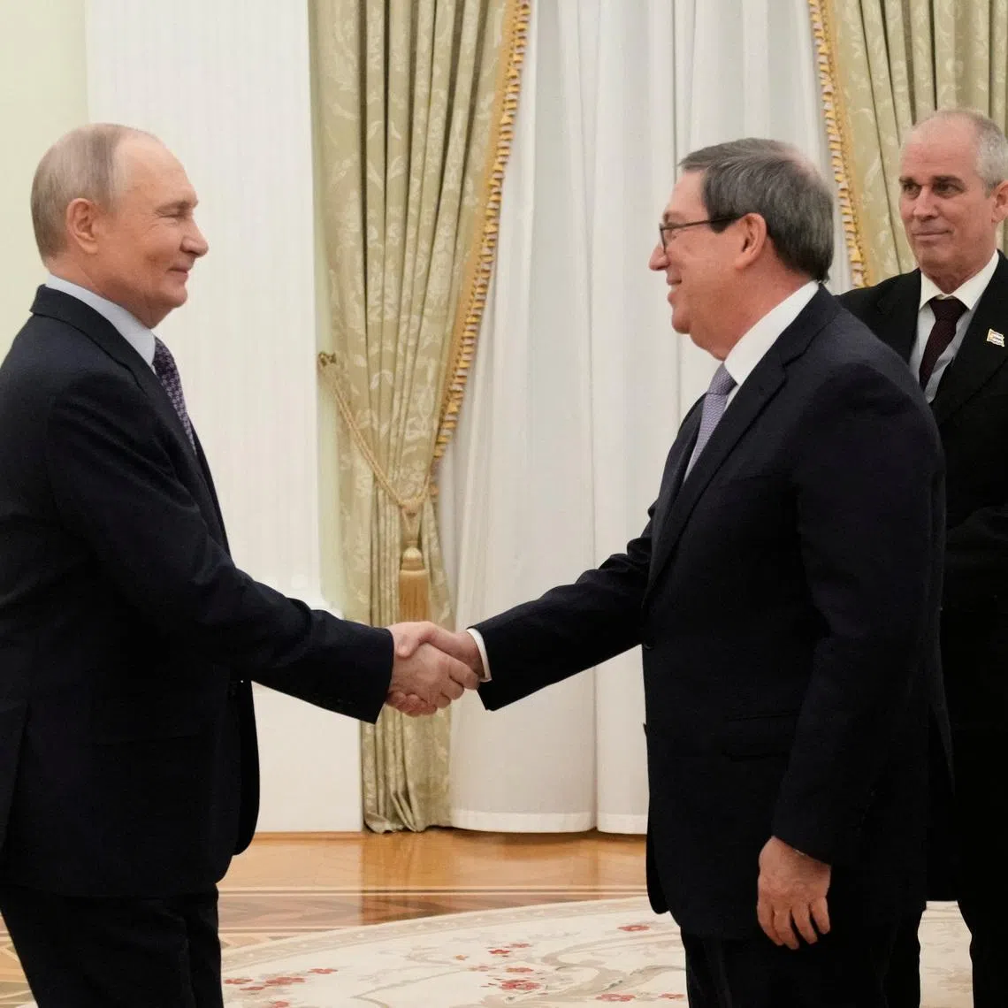 Russian President Vladimir Putin shakes hands with Cuban Foreign Minister Bruno Rodriguez Parrilla during their meeting at the Senate Palace of the Kremlin in Moscow, Russia, February 18, 2026. Pavel Bednyakov/Pool via REUTERS