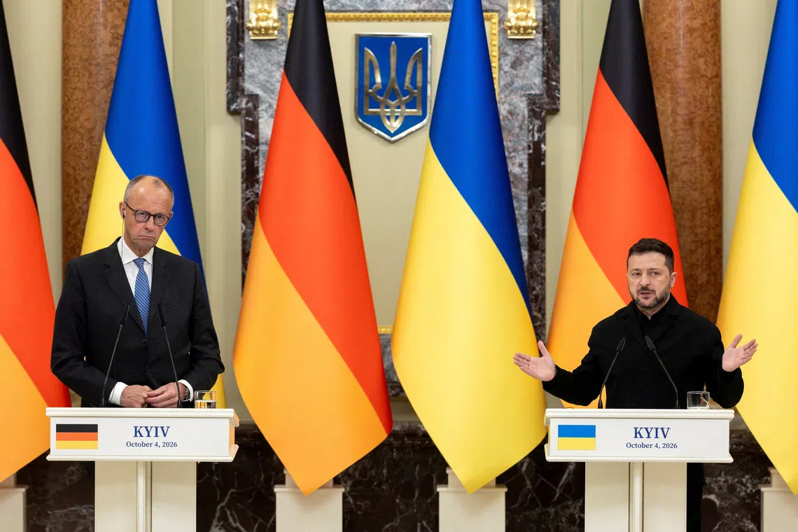Ukraine’s President Volodymyr Zelenskiy and German Chancellor Friedrich Merz attend a press conference, in Kyiv, Ukraine, on Oct 4.