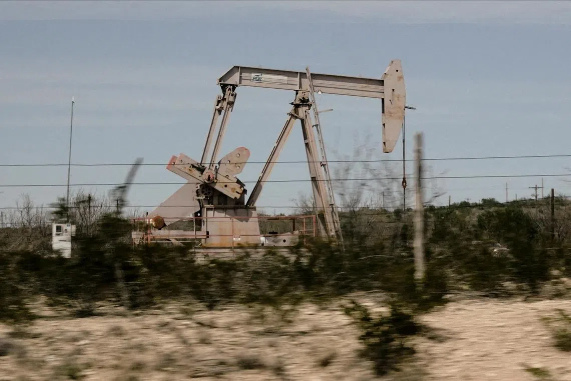 FILE PHOTO: A pump jack drills oil crude from the Yates Oilfield in West Texas’s Permian Basin near Iraan, Texas, U.S., March 17, 2023. Picture taken through glass. REUTERS/Bing Guan/File Photo