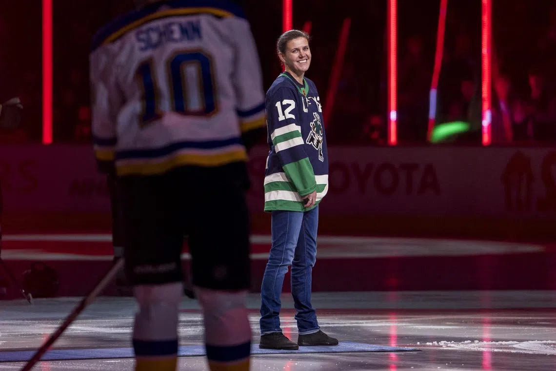Christine Sinclair smiles prior to the ceremonial puck drop before a NHL game between the Vancouver Canucks and the St. Louis Blues in December 2022.