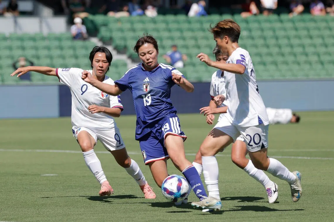 Japan's Momoko Tanikawa (in blue) in action during their 2-0 Women’s Asian Cup win in Perth on March 4.
