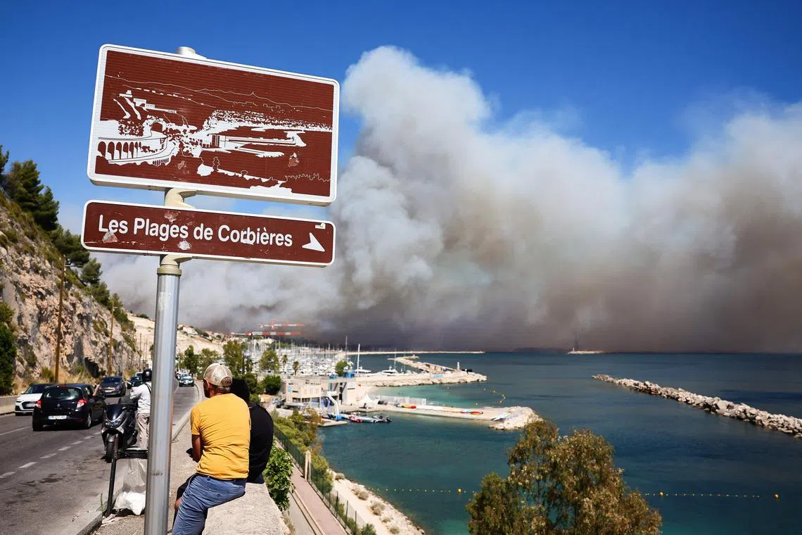 The fire started in a vehicle on its way to the airport, roaring across 350 hectares by the afternoon and sending plumes of acrid smoke billowing into the sky.