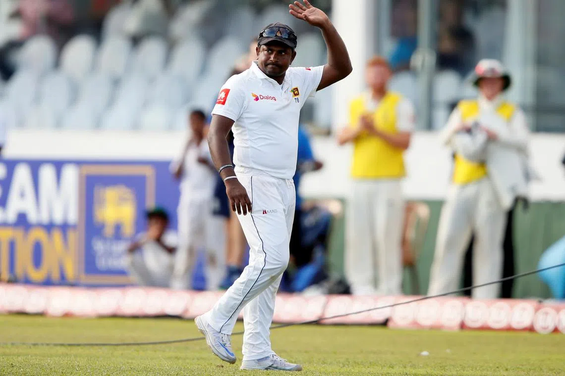 FILE PHOTO: Cricket - England v Sri Lanka, First Test - Galle, Sri Lanka - November 8, 2018. Sri Lanka's Rangana Herath waves at the fans as he walks off the field with his teammates at the end of England's second inning. REUTERS/Dinuka Liyanawatte/File Photo