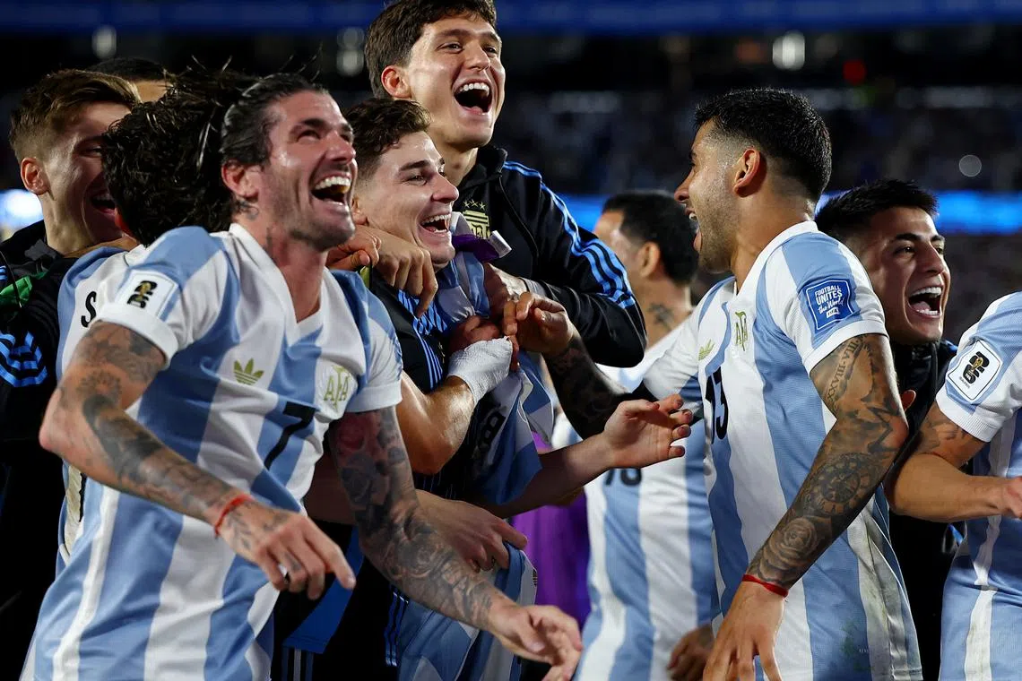 Soccer Football - World Cup - South American Qualifiers - Argentina v Brazil - Estadio Mas Monumental, Buenos Aires, Argentina - March 25, 2025 Argentina's Rodrigo De Paul, Julian Alvarez and Cristian Romero celebrate after qualify to the World Cup 2026 REUTERS/Agustin Marcarian