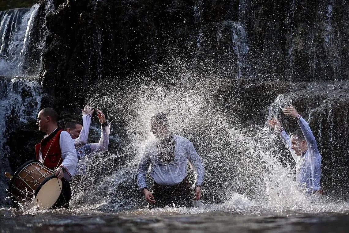 Men sing and dance in the waters of Dokuzak waterfall during a celebration of Epiphany Day, near the town of Malko Tarnovo, Bulgaria, January 6, 2026. REUTERS/Stoyan Nenov TPX IMAGES OF THE DAY