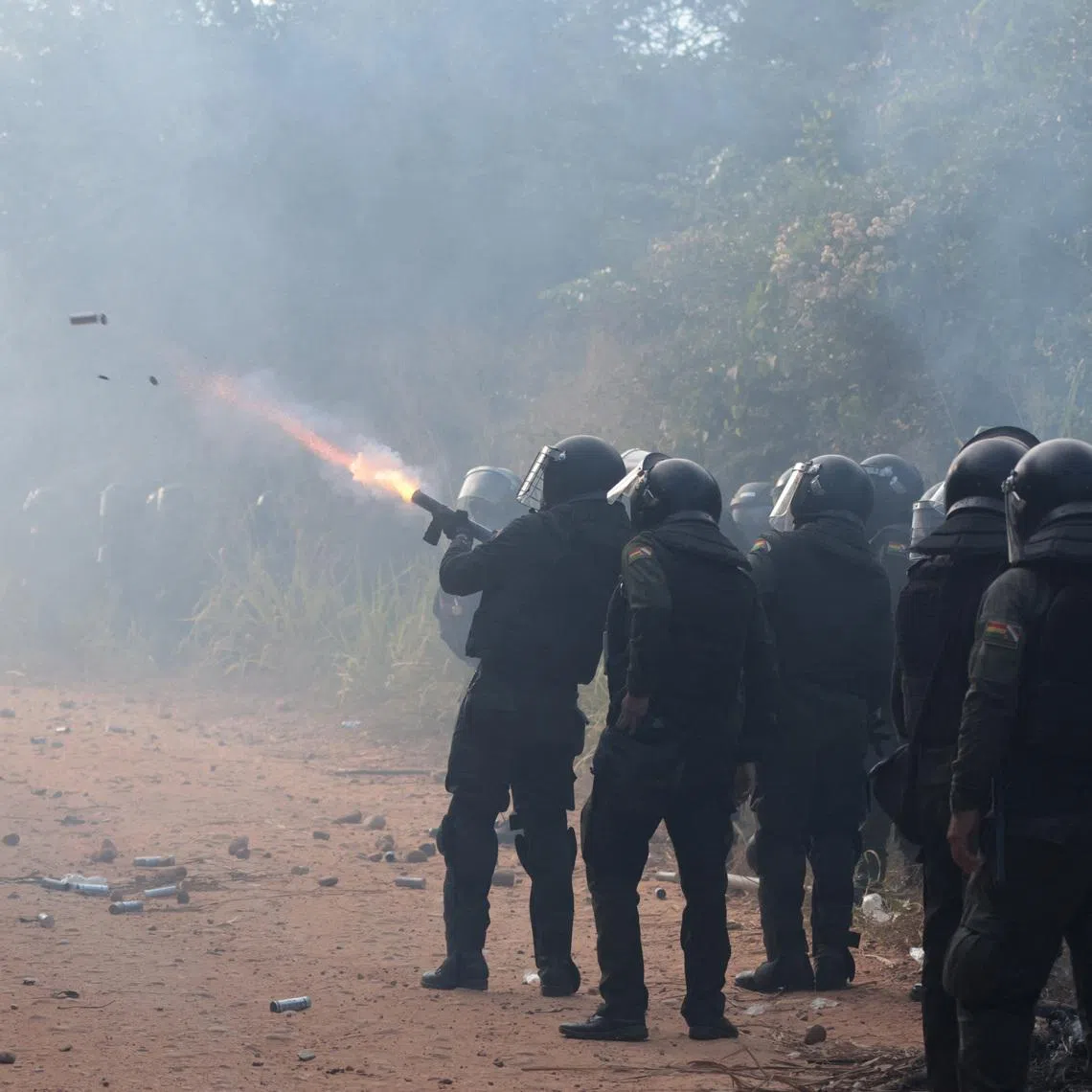 Police officers fire tear gas while clashing with community members who seized the Humberto Suarez oil facility to call for the resignation of President Rodrigo Paz, as ongoing protests have led to shortages of fuel and food, in Santa Rosa del Sara, Bolivia, June 3, 2026. REUTERS/Ipa Ibanez