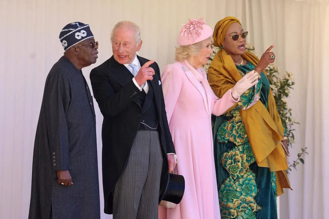 Nigerian President Bola Tinubu and first lady Oluremi Tinubu, Britain's King Charle and Queen Camilla on the dais in the Quadrangle at the inspection of the Guard of Honour during a ceremonial welcome at Windsor Castle on the first day of the president's state visit, on March 18, 2026 in Windsor, Britain. Chris Jackson/Pool via REUTERS