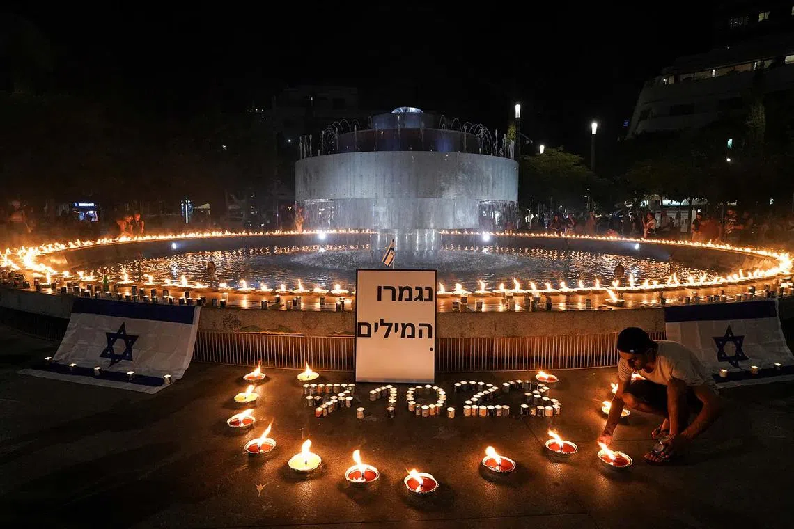 People gathering and lighting candles to show solidarity with Israel and remember the victims following an attack by Hamas gunmen from Gaza, at Dizengoff square in Tel Aviv, Israel, on Oct 12.