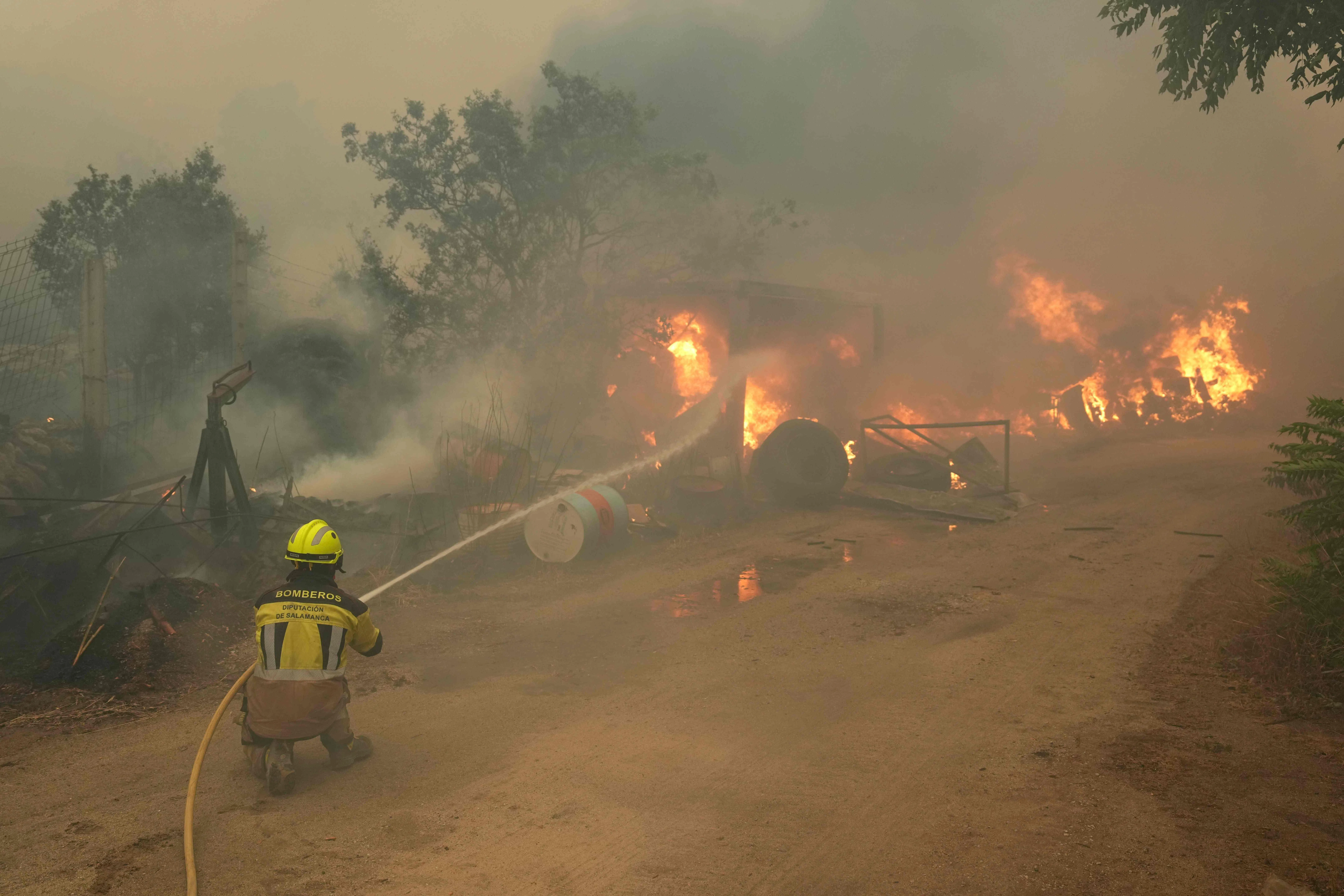 Firefighters battle a wildfire in Cebreros area, near Avila, 80 kms west of Madrid on July 24, 2026. Spain declared a national emergency in the Madrid region and in the province of Avila, near the capital, on July 23, 2026, in the wake of several wildfires burning out of control. Scientists have long warned that climatechange caused by human use of fossil fuels will make periods of drought more intense and longer-lasting, creating the ideal conditions for wildfires. (Photo by Cesar MANSO / AFP)
