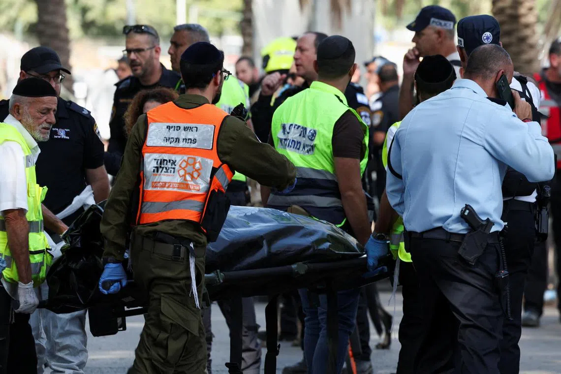 Israeli emergency services work at the scene where a truck rammed into pedestrians at a bus stop north of Tel Aviv.