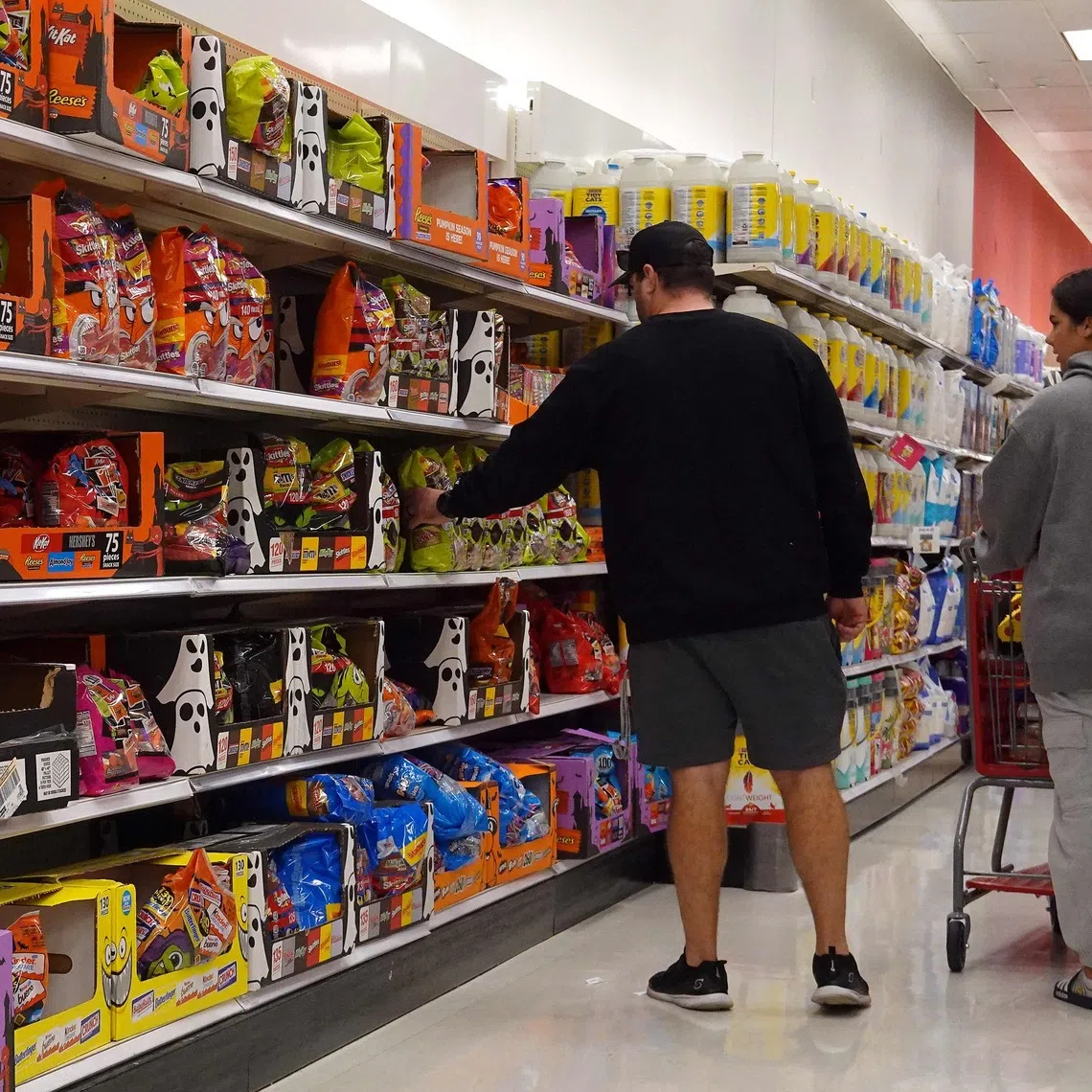 Customers shop at a Target store in California on Oct 30. If inflation resurges, a constrained Fed may keep rates from falling.
