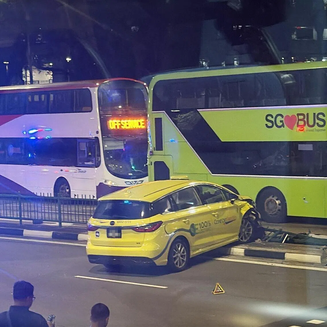 In a photo of the aftermath of the accident, it appears that the taxi had collided with the road divider railing.