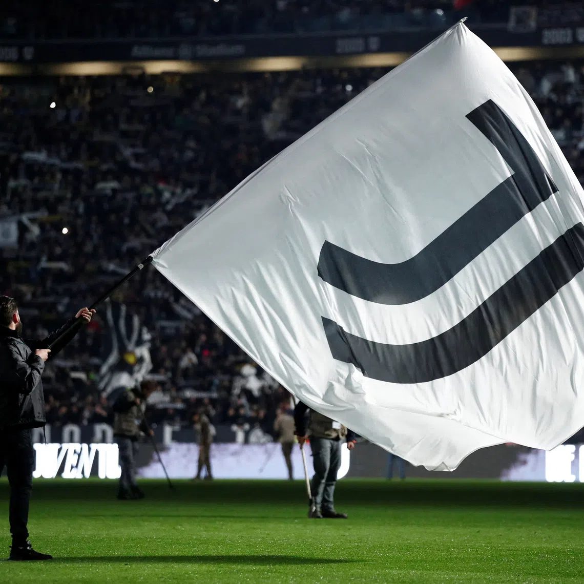 FILE PHOTO: Soccer Football - Serie A - Juventus v Torino - Allianz Stadium, Turin, Italy - November 8, 2025 A Juventus flag is waved inside the stadium before the match REUTERS/Alessandro Garofalo/File Photo
