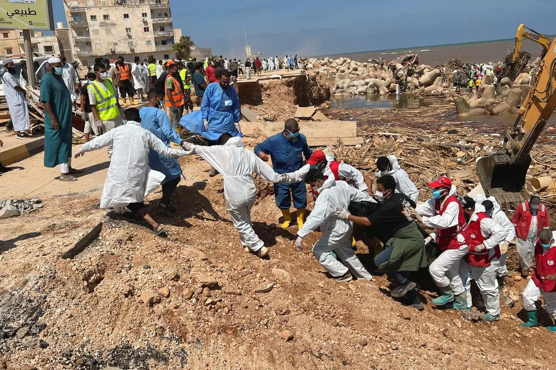 Rescuers search for bodies at a beach in Libya's Derna.     