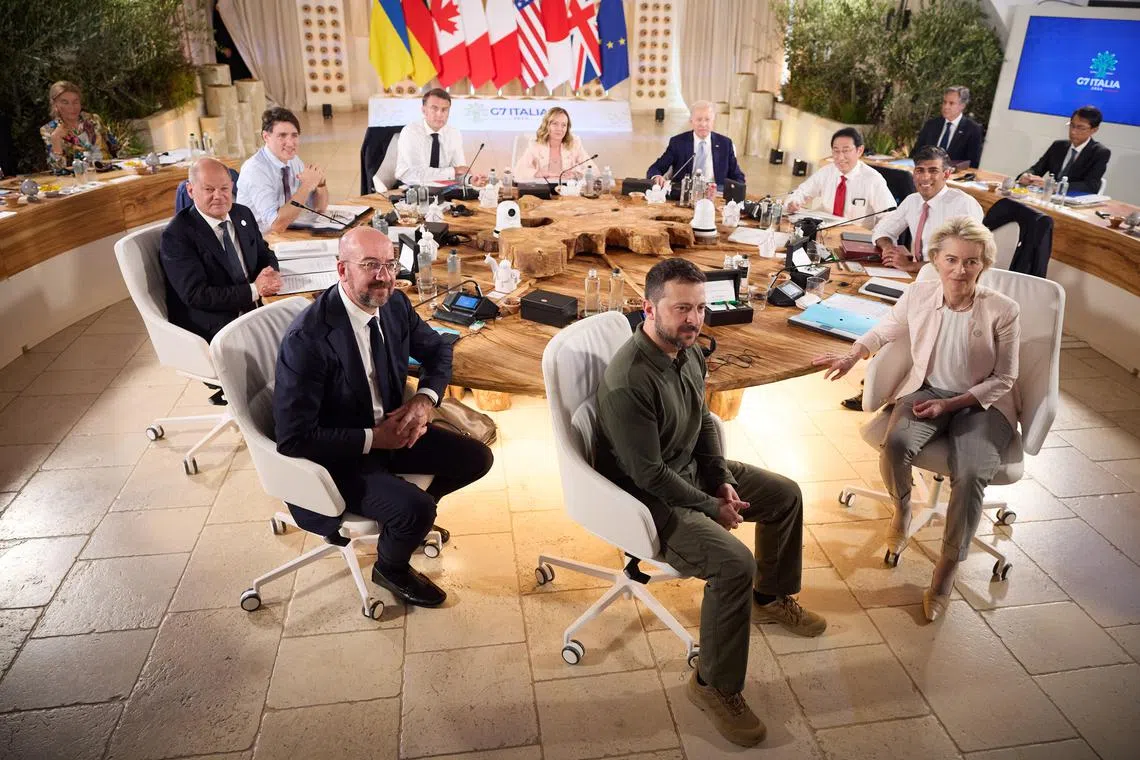 Ukrainian President Volodymyr Zelensky (front, centre) at the G-7 summit in Italy on June 13, with G-7 and European leaders.