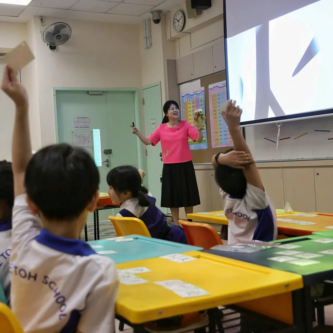Madam Zhang Yinan, 43, senior teacher for Chinese language at Mee Toh School, teaching a class of primary 1 pupils by leveraging on games, roleplay elements and animation to reinforce word recognition during a Chinese Language (CL) open classroom session, conducted by Ministry of Education's Mother Tongue Language Branch, at Mee Toh School on April 4, 2025. The session was streamed live to all primary CL teachers across Singapore. "If the class is enjoyable and interesting, the pupils will not feel difficulty in learning the language. With the use of animation and games, pupils show more enthusiasm during class," said Madam Zhang. "The use of gamification and roleplay to supplement their textbook and word cards helps to reinforce their ability to recognise the words they just learn. It makes learning an organic process that is both fun and effective." Madam Zhang added that parents have also provided feedback that their children's interest in learning Chinese language has increased. "For me, it is difficult to write Chinese characters but Madam Zhang uses songs to make it easy to learn new words," said primary 1 pupil Jevier Soh, seven. "In King's Throne, I get to take part in a friendly competition with my classmates and learn different words in the process," added primary 1 pupil Zhou Yi Chen, seven.