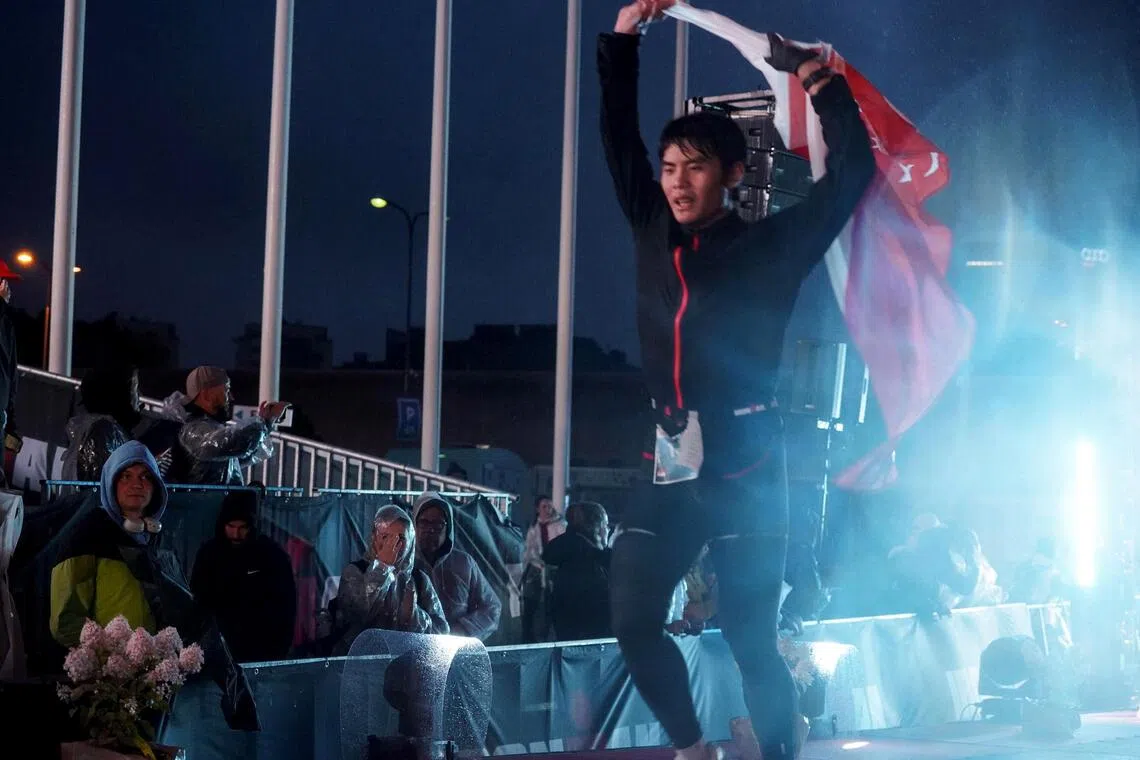 ACJC student Xie Ze Kai, 18, crosses the finishing line at Ironman Tallinn. He completed the race in 12:38:24.