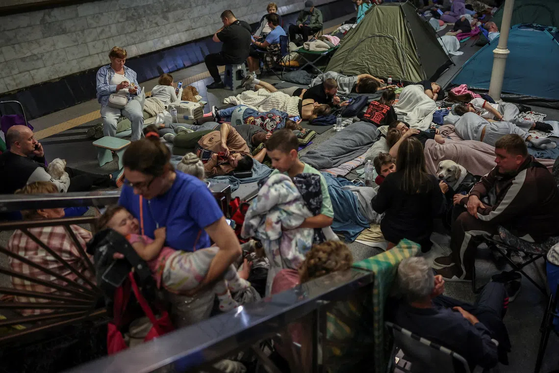 People take shelter inside an overcrowded metro station during a Russian missile and drone strike in Kyiv, Ukraine.