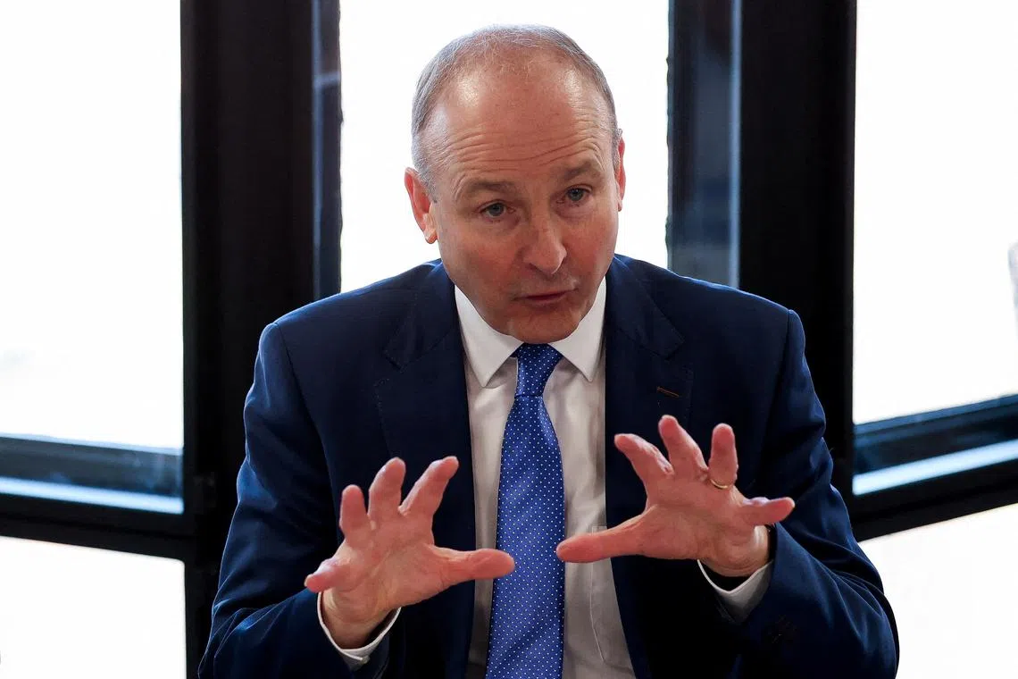 FILE PHOTO: Ireland's Taoiseach (Prime Minister) Micheal Martin attends a business roundtable with British Prime Minister Keir Starmer (not pictured) at the UK-Ireland Summit in Liverpool, Britain, March 6, 2025. REUTERS/Phil Noble/Pool/File Photo