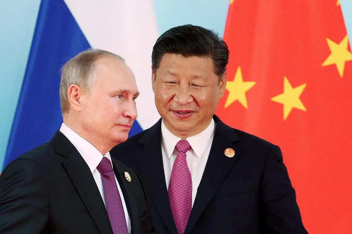 FILE PHOTO: Chinese President Xi Jinping (R) stands next to Russian President Vladimir Putin as he arrives for a group photo  during the BRICS Summit at the Xiamen International Conference and Exhibition Center in Xiamen, southeastern China's Fujian Province, China September 4, 2017. REUTERS/Wu Hong/Pool/File Photo