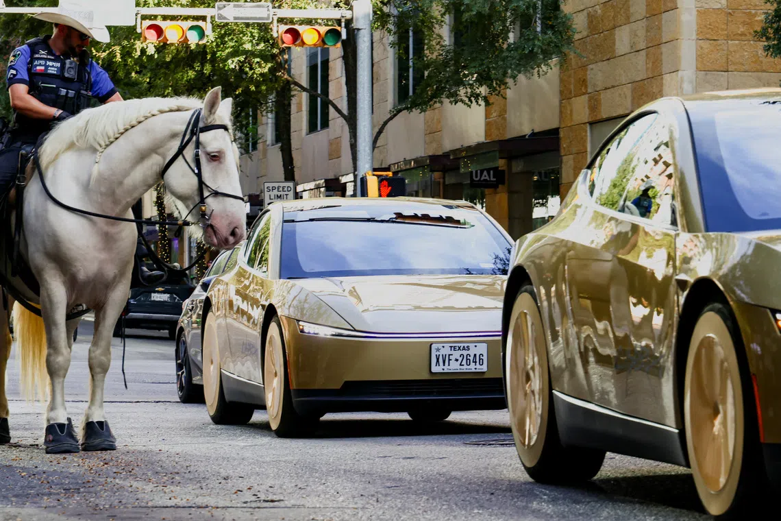 Mounted police patrols as gold-colored Tesla Cybercabs arrive for an event in downtown Austin, Texas, U.S., September 3, 2026. REUTERS/Kaylee Greenlee TPX IMAGES OF THE DAY