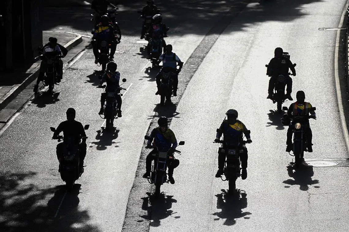 TOPSHOT - Supporters of Venezuelan President Nicolas Maduro on motorcycles attend a rally in Caracas on January 8, 2025. Venezuela was on tenterhooks Wednesday as opposition protesters called for protests and reports of detained leaders and activists, two days before President Nicolas Maduro is due to be sworn in for a third consecutive term. (Photo by Federico PARRA / AFP)
