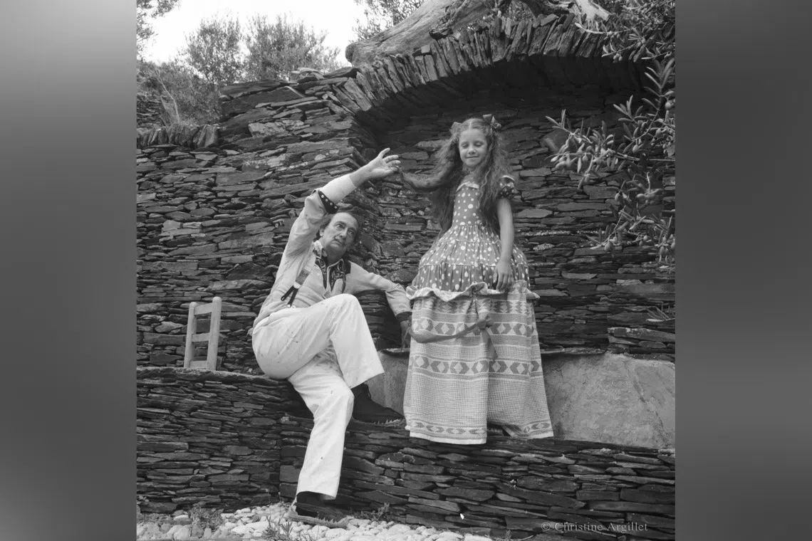 Surrealist artist Salvador Dali pulling Christine Argillet's hair.