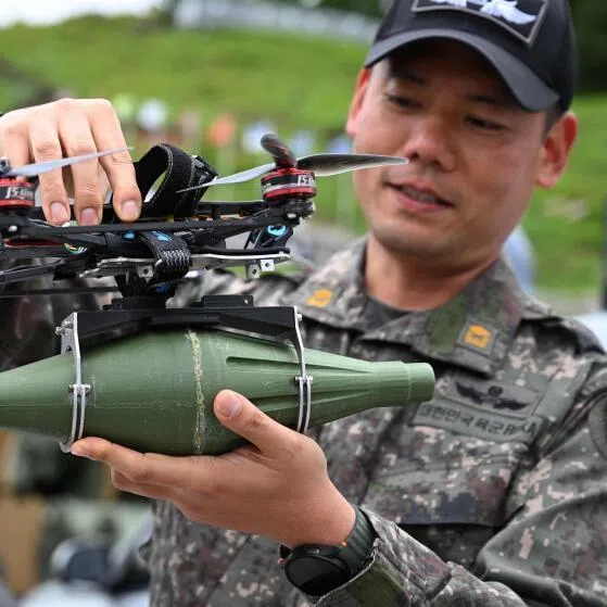 A South Korean soldier holds a multi-purpose tactical drone during a live-fire military exercise on May 21. Emerging security threats, from quantum technology to drone warfare, urgently need to become mainstream conversations, the writer argues. 
