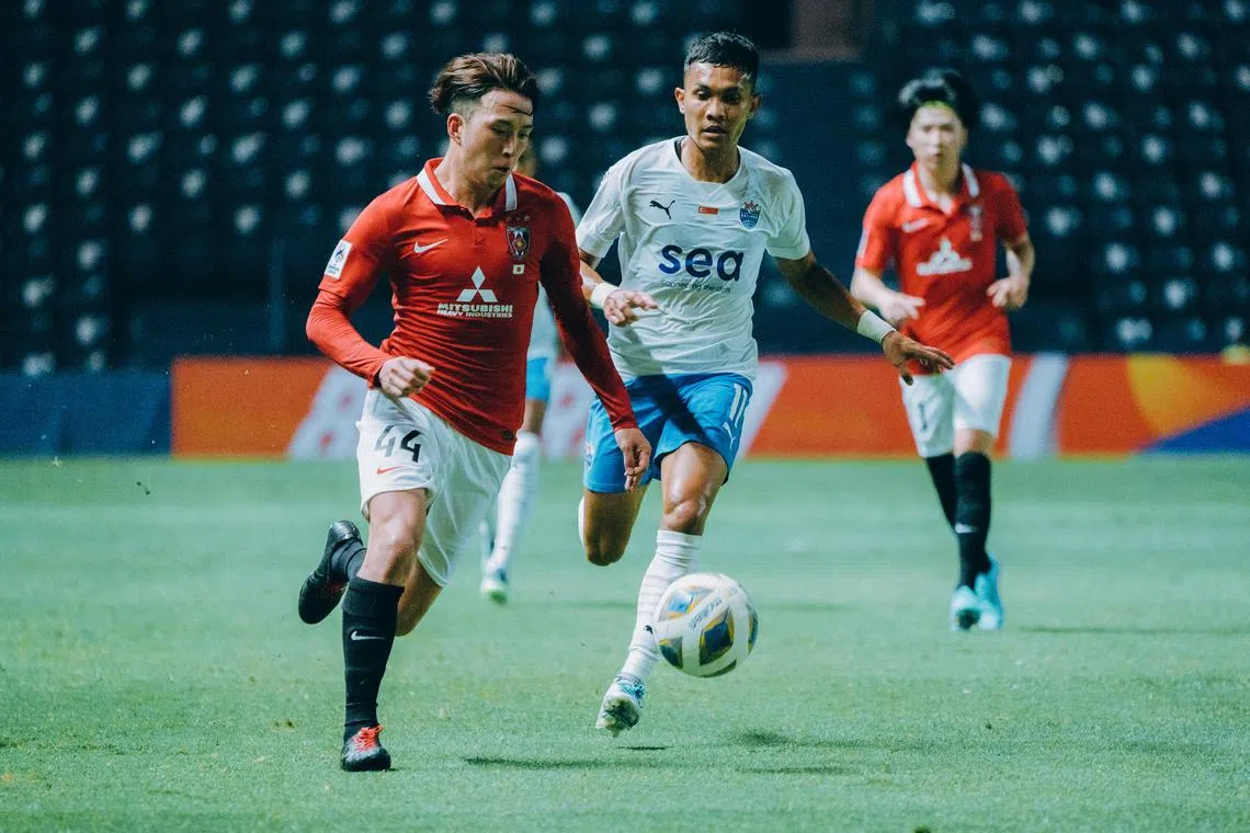 Urawa Red Diamonds' Ayumu Ohata dribbles away from Lion City Sailors winger Hafiz Nor. The Sailors lost 4-1 to the Japanese side on their Asian Champions League debut.