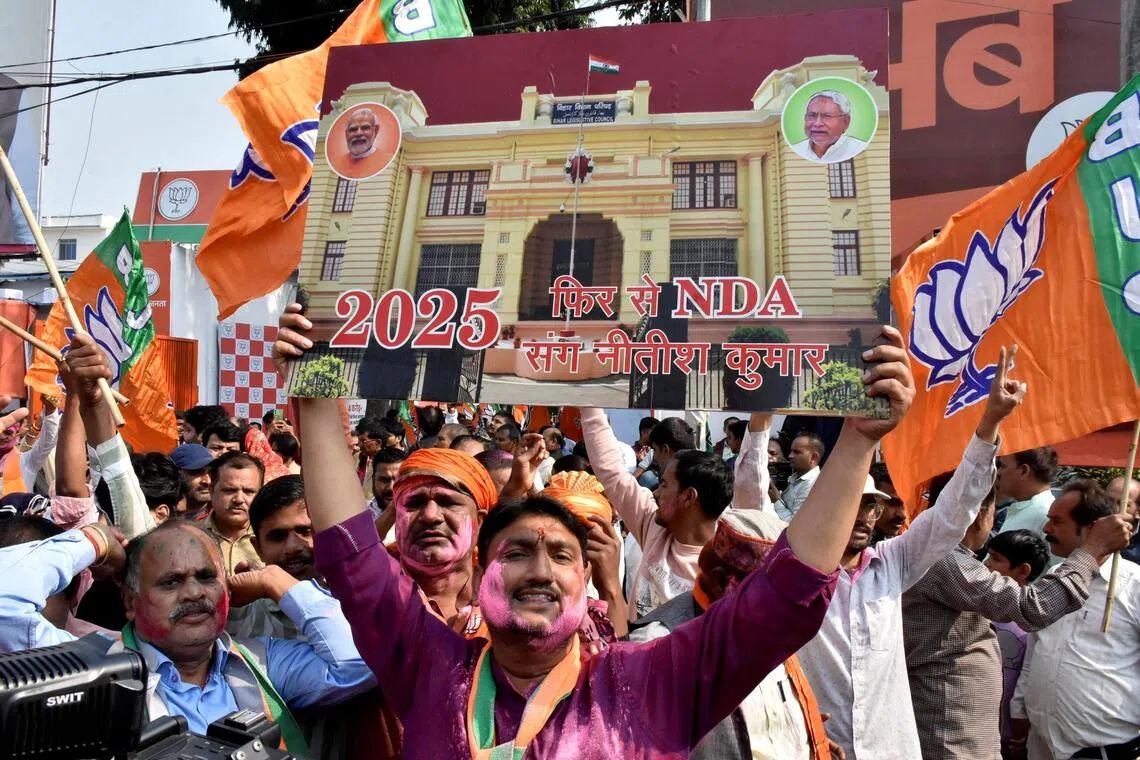 Bharatiya Janata Party (BJP) supporters celebrate in Patna, India, on Nov 14.