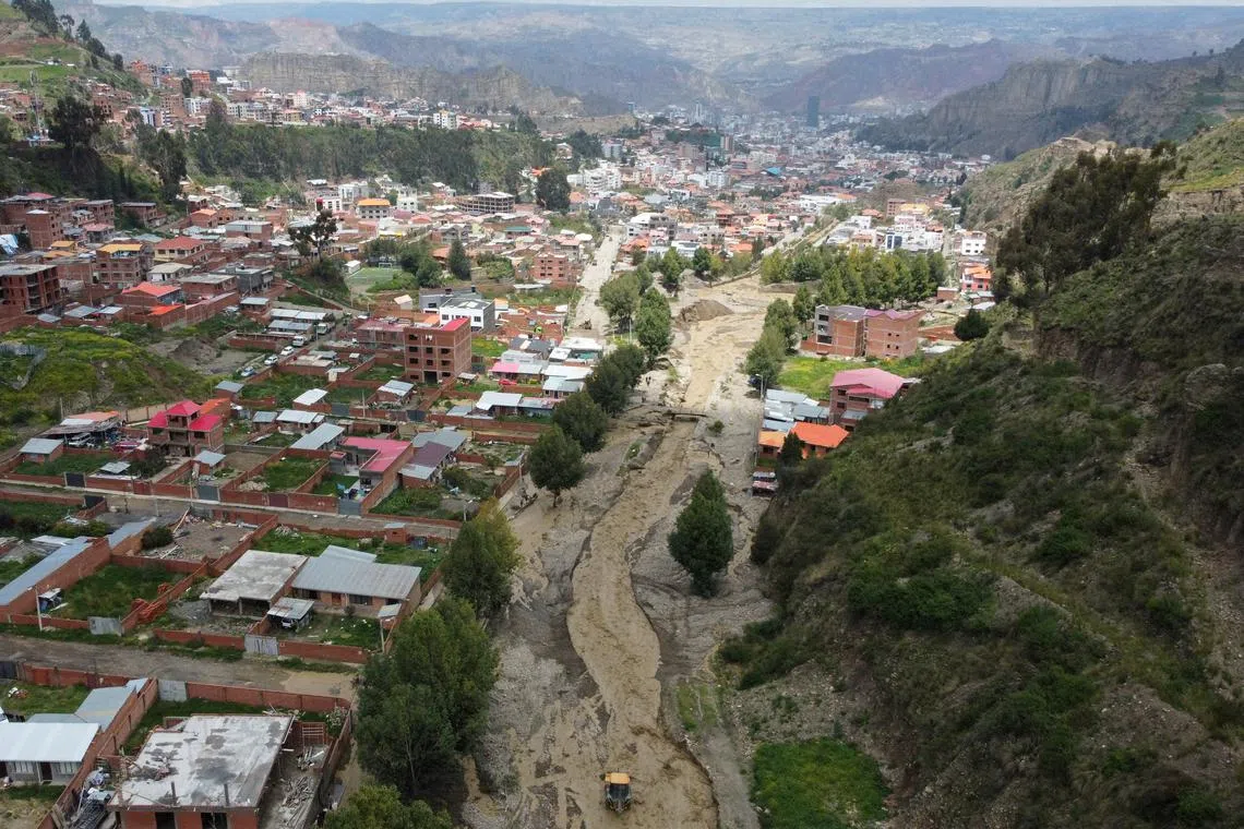 A drone view shows the Kellumani river overflowing due to heavy rains in the Chijipata area, in La Paz, Bolivia March 9, 2024. REUTERS/Claudia Morales