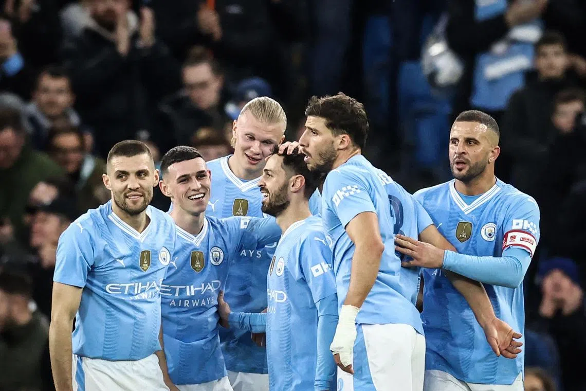 Manchester City's Bernardo Silva (centre) celebrates with teammates after scoring his City's second goal.