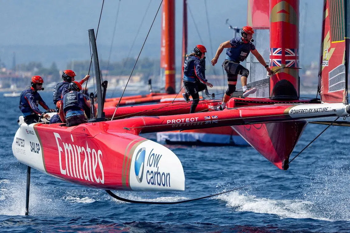 FILE PHOTO: Ben Ainslie, driver of Emirates Great Britain SailGP Team, and Hannah Mills, strategist of Emirates Great Britain SailGP Team, run across the F50 catamaran on Race Day 2 of the France Sail Grand Prix in Saint-Tropez, France, September 10, 2023. Felix Diemer for SailGP/Handout via REUTERS/File Photo