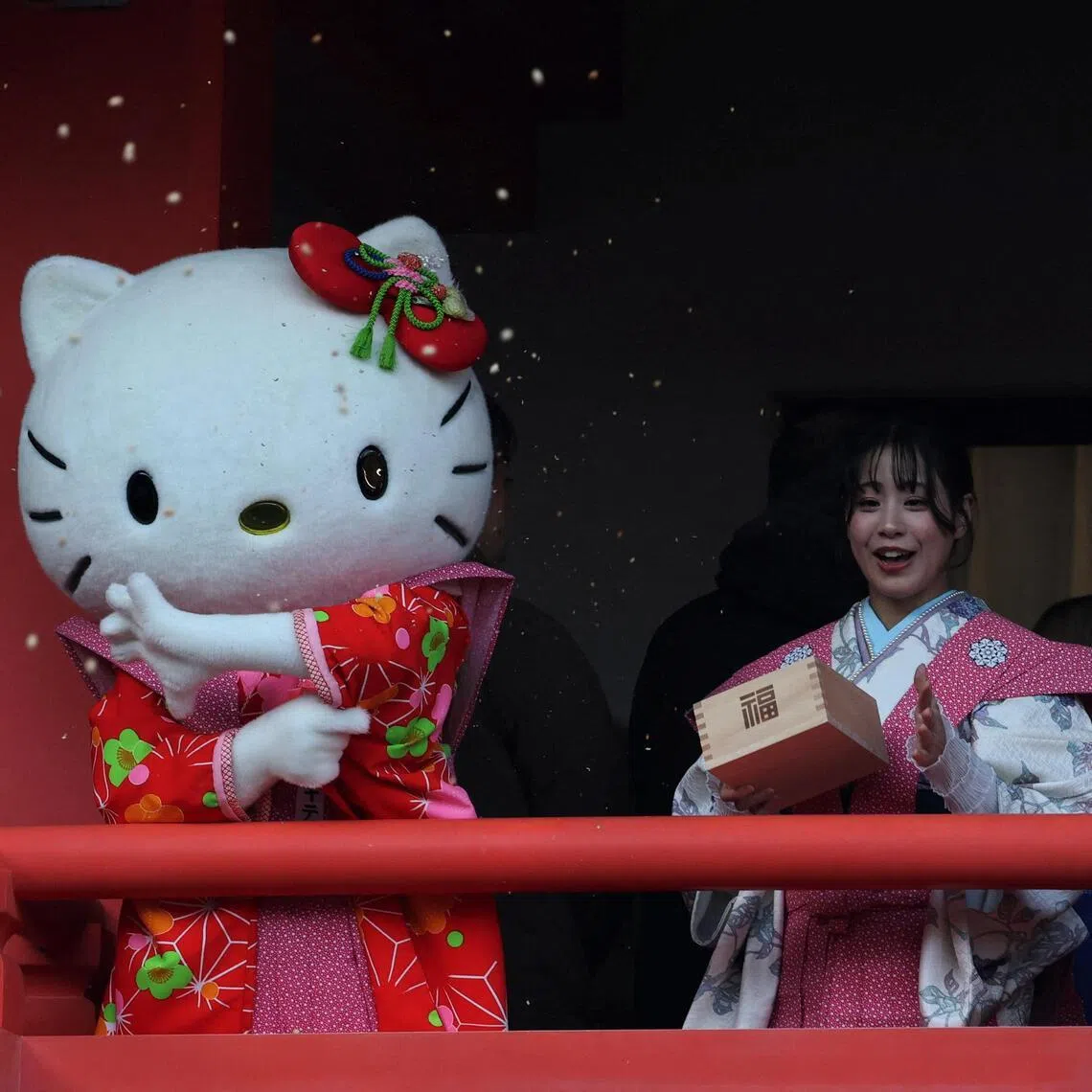 A participant dressed as Hello Kitty throws beans during the annual Setsubun ceremony to celebrate the upcoming arrival of spring.