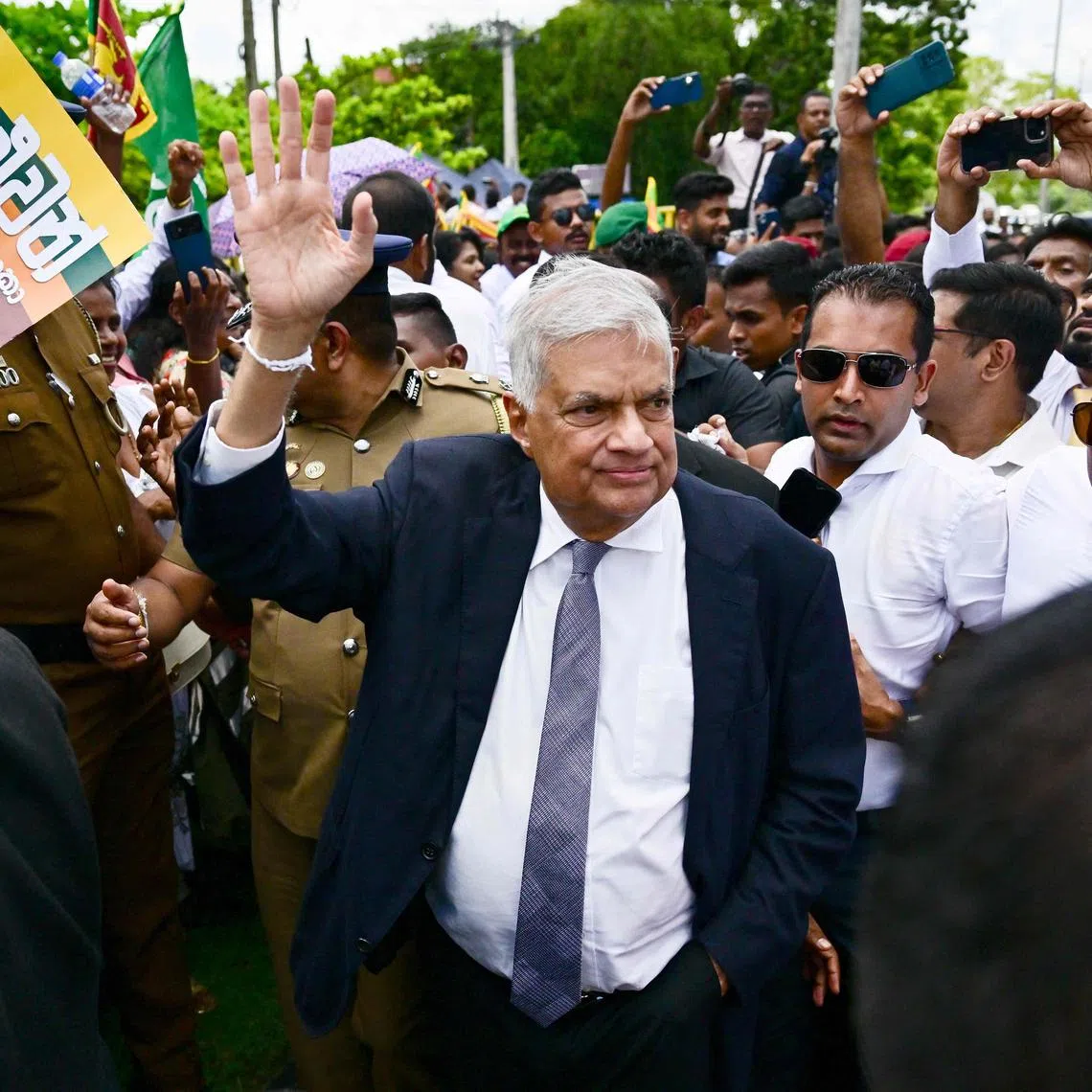 (FILES) Sri Lanka's President and United National Party presidential candidate Ranil Wickremesinghe (C), waves to supporters after filing his nomination papers for the upcoming presidential elections, in Colombo on August 15, 2024. Sri Lanka's former president Ranil Wickremesinghe was arrested on August 22 for allegedly "misusing government funds", a senior police detective told AFP. Wickremesinghe was taken into custody after being questioned about a September 2023 visit to London to attend a ceremony for his wife at a British university while he was head of state, the officer said. (Photo by Ishara S. KODIKARA / AFP)