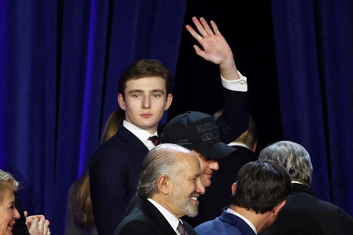 Republican presidential nominee and former US President Donald Trump's son Barron Trump waves during Trump rally in 2024.