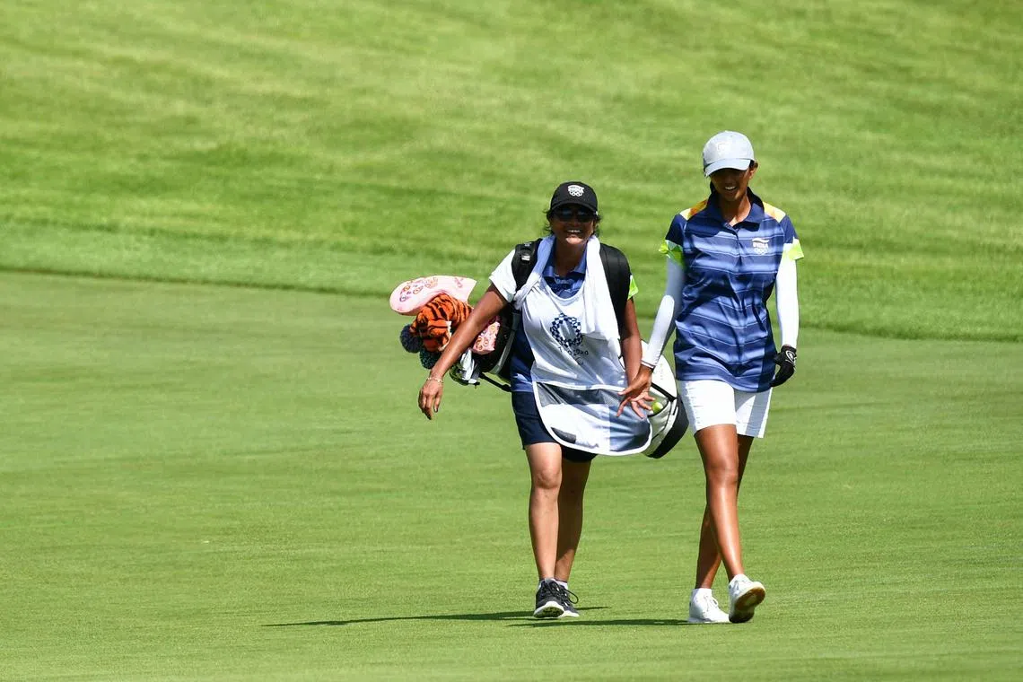 India's Aditi Ashok and caddie, her mother Maheshwari known to everyone as "Mash", walk to the 18th hole during the Tokyo Olympics.