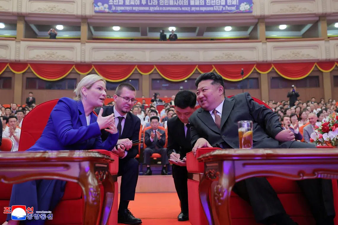 Russian Culture Minister Olga Lyubimova speaks to North Korean leader Kim Jong Un during a performance, in Pyongyang on June 29.