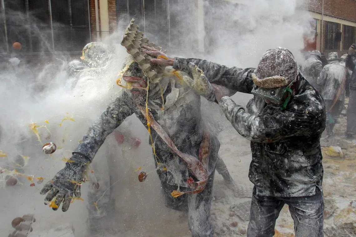 People dressed in miltary costumes taking part in a fake coup d'etat performances during the traditional fest called 'The floured ones' (Els Enfarinats) held in the village of Ibi, Alicante, Spain, Dec 28, 2023. 