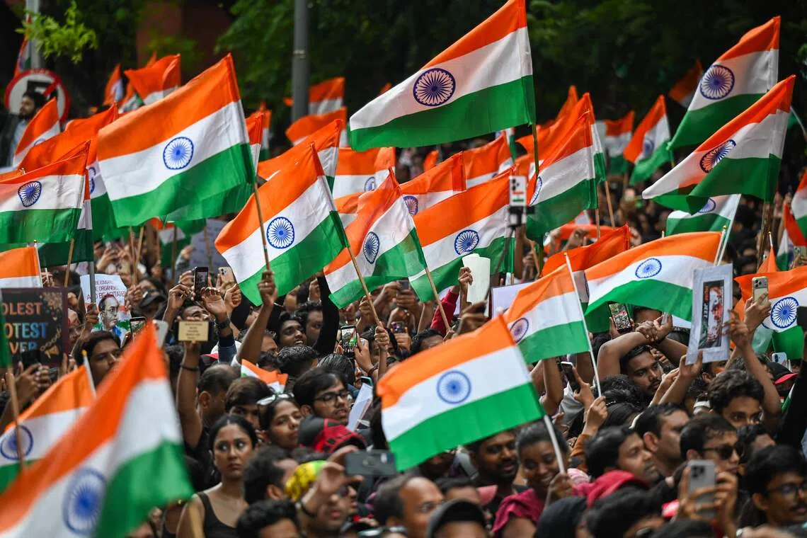 Cockroach Janta Party (CJP) supporters wave flags a day after the resignation of India’s Education Minister Dharmendra Pradhan on July 26.