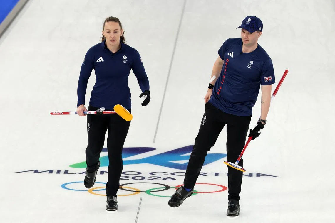 Milano Cortina 2026 Olympics - Curling - Mixed Doubles Round Robin Session 7 - Britain vs Canada - Cortina Curling Olympic Stadium, Cortina d'Ampezzo, Italy - February 07, 2026. Bruce Mouat of Britain and Jennifer Dodds of Britain after winning against Brett Gallant of Canada and Jocelyn Peterman of Canada REUTERS/Issei Kato