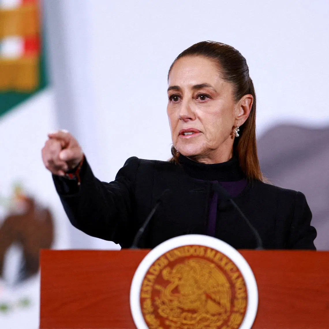 FILE PHOTO: Mexico's President Claudia Sheinbaum speaks during a press conference about the wave of violence in Mexico, following the killing of Mexican drug lord Nemesio Oseguera, known as 'El Mencho', in a military operation on Sunday, at Palacio Nacional, in Mexico City, Mexico, February 23, 2026. REUTERS/Raquel Cunha/File Photo