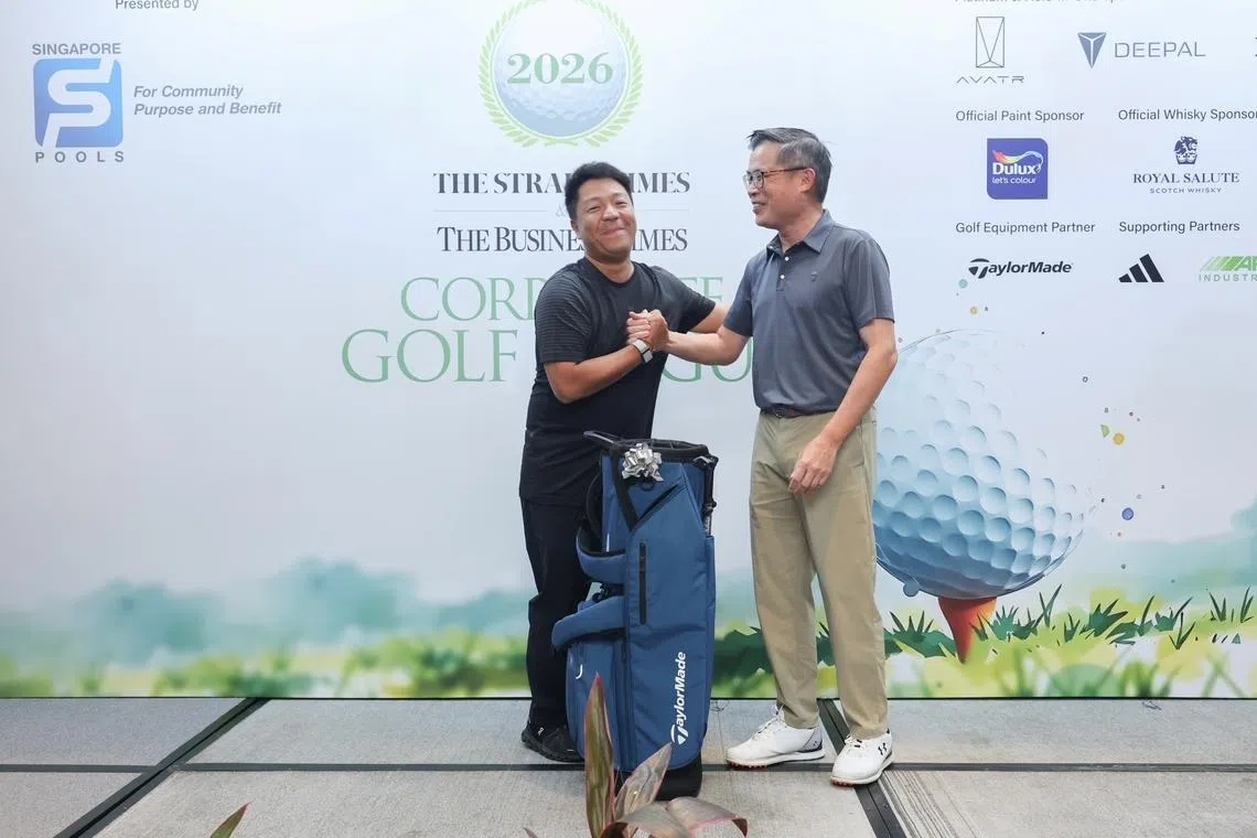 Henry Mo is all smiles after he receives the individual champion’s prize from Jaime Ho, editor of The Straits Times. 