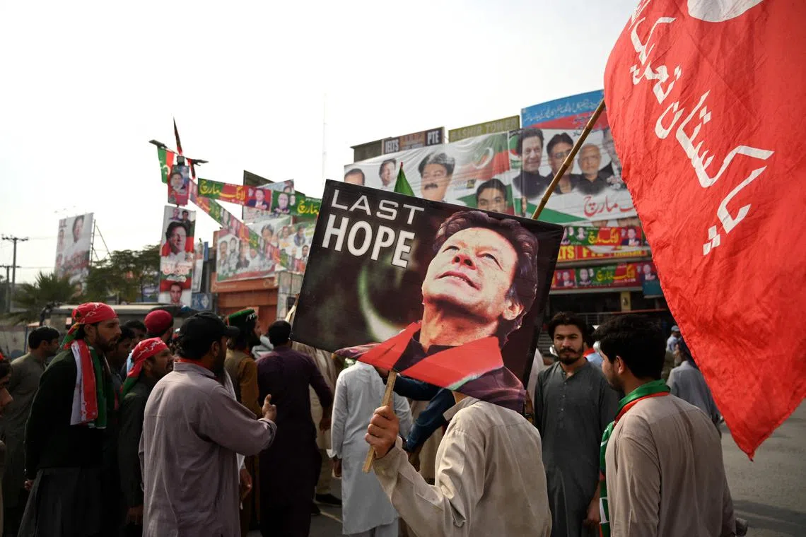 Supporters of former Pakistani prime minister Imran Khan, take part in a protest near the container truck a day after the assassination attempt on Nov 4, 2022.