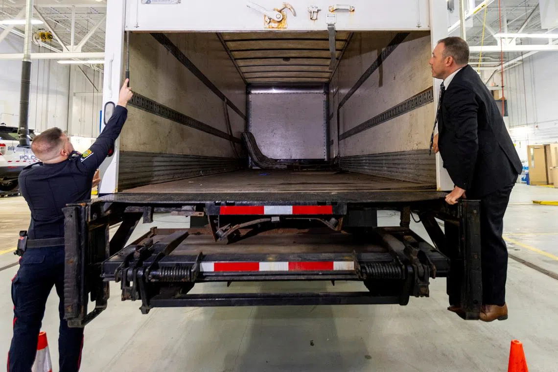 FILE PHOTO: Police officers open the back of the truck used in the heist after authorities gave details of the arrests made one year after some 400 kg (882 pounds) of gold and almost $2 million USD in cash was stolen from Toronto Pearson International Airport, at a news conference in Brampton, Ontario, Canada April 17, 2024.  REUTERS/Carlos Osorio/File Photo