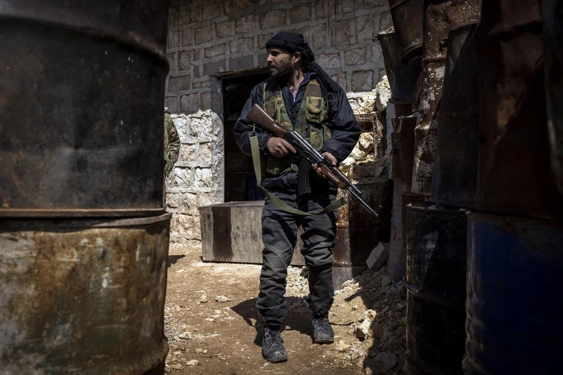 FILE Ñ A fighter from Hayat Tahrir al-Sham at a frontline base in Maaret al-Naasan, Syria, on March 25, 2021. For several years, the group focused on securing and governing the area it held. (Ivor Prickett/The New York Times)