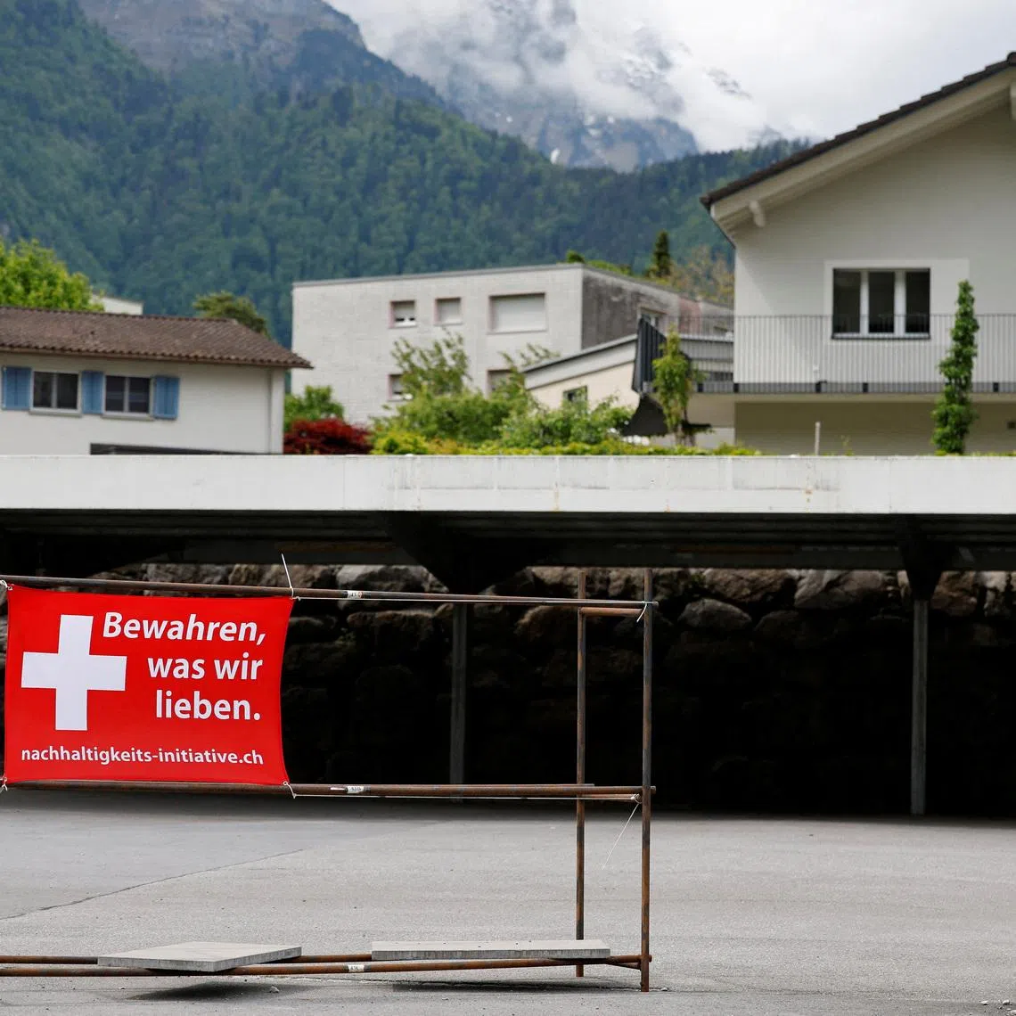 A sign is pictured ahead of a June 14 vote on a plan backed by the right-wing Swiss People's Party (SVP) to cap the population at 10 million inhabitants, in Glarus, Switzerland, May 18, 2026. The sign reads: \"Preserve what we love\". REUTERS/Stefan Wermuth